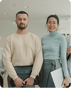 Team members with laptop and portfolio in professional setting