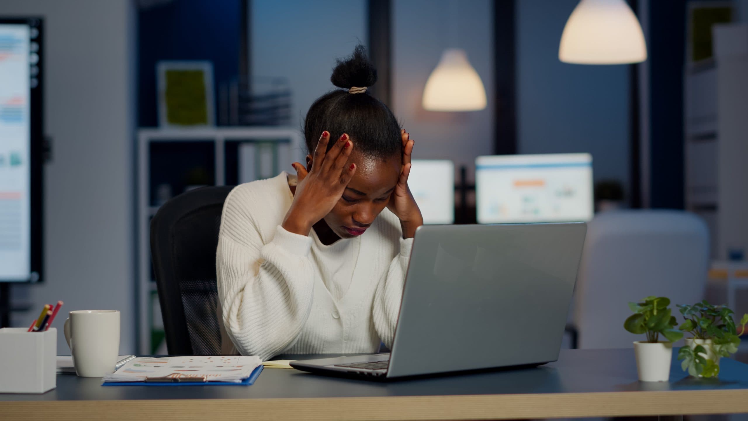 Workplace burnout in Nigeria illustration showing exhausted office employee