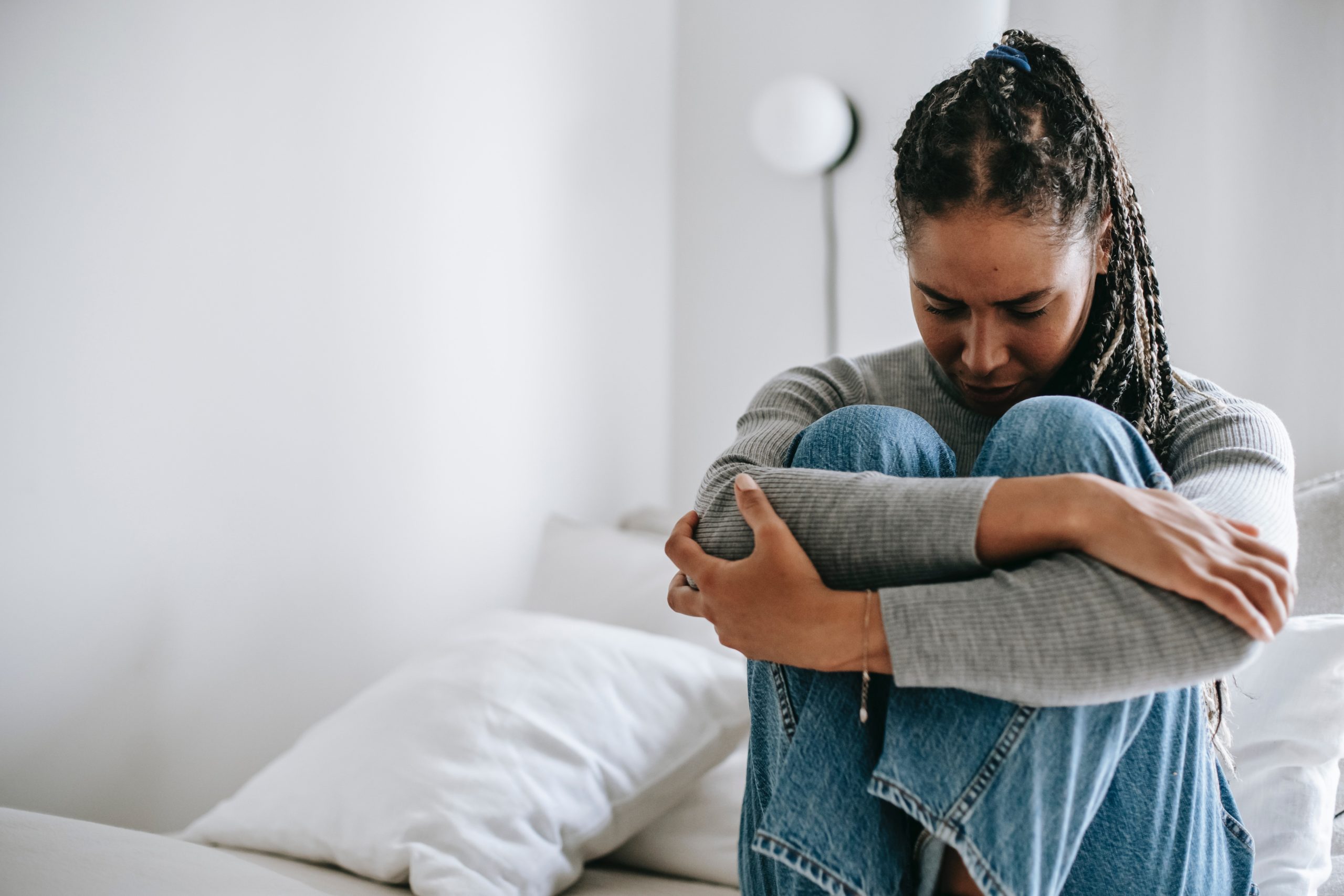 Photo by Alex Green: https://www.pexels.com/photo/upset-ethnic-woman-embracing-knees-on-bed-5699859/