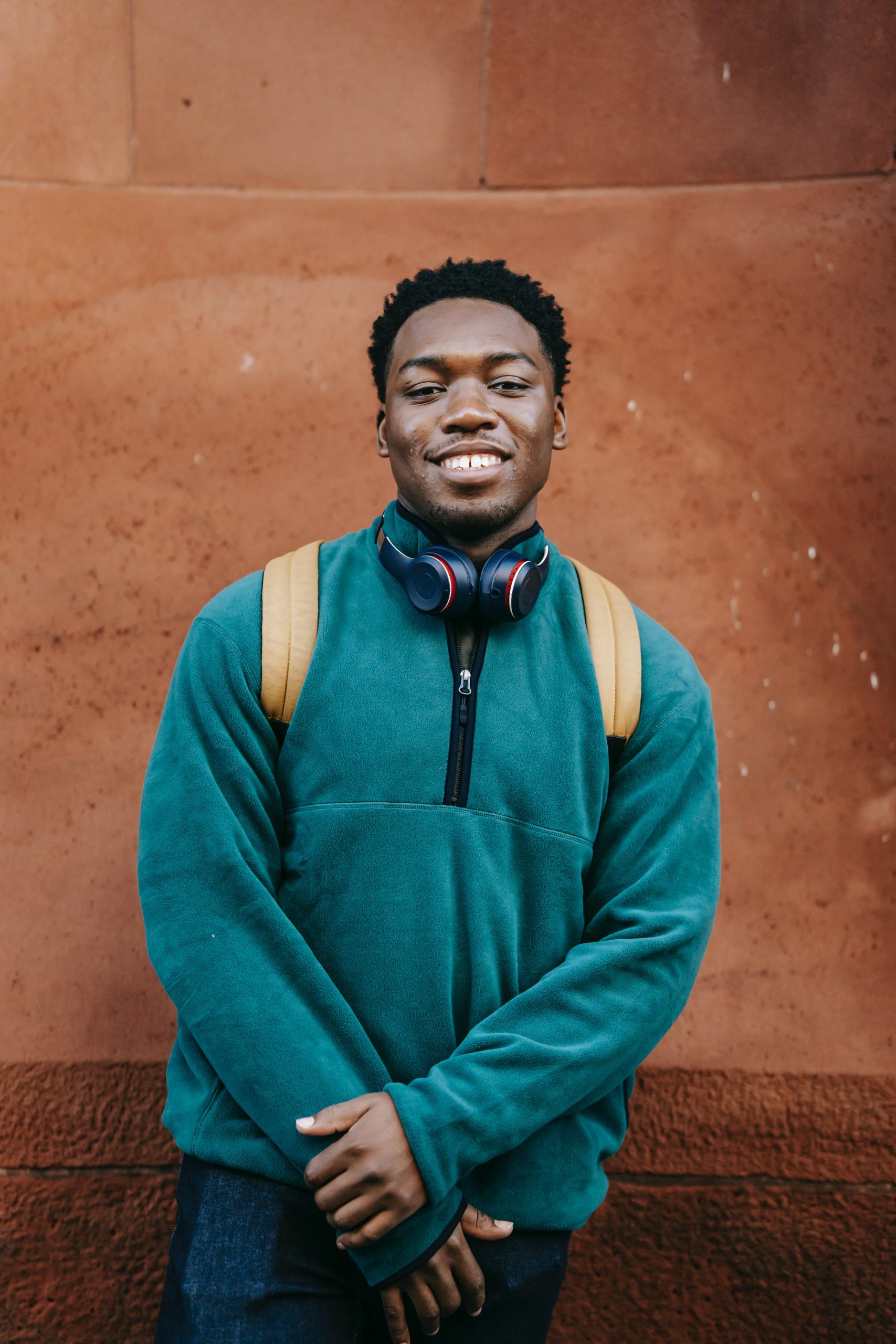 Photo by Keira Burton: https://www.pexels.com/photo/cheerful-young-ethnic-male-millennial-standing-near-stone-wall-and-smiling-6147118/