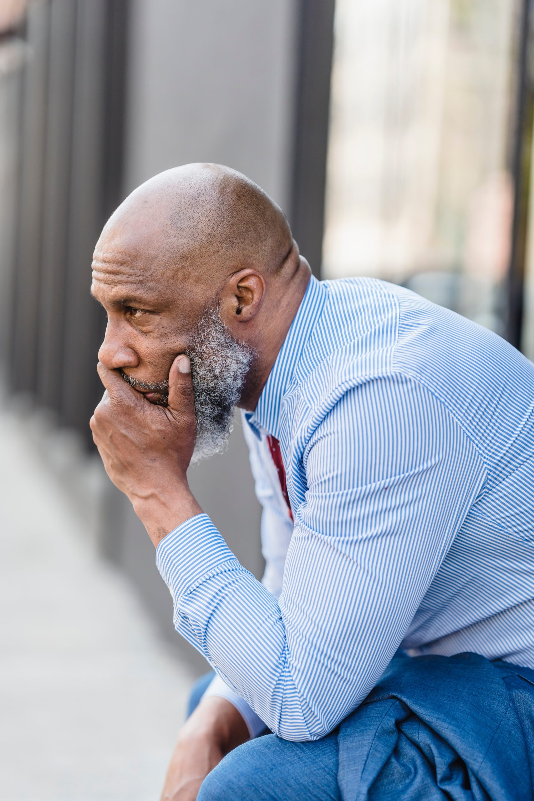 Photo by Nicola Barts : https://www.pexels.com/photo/worried-black-worker-on-street-7925808/