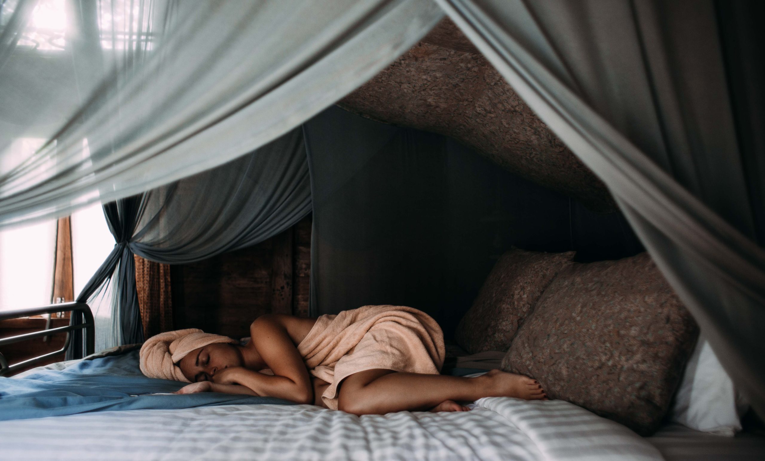 Photo by Rachel Claire: https://www.pexels.com/photo/woman-lying-on-bed-wrapped-around-a-towel-5864643/