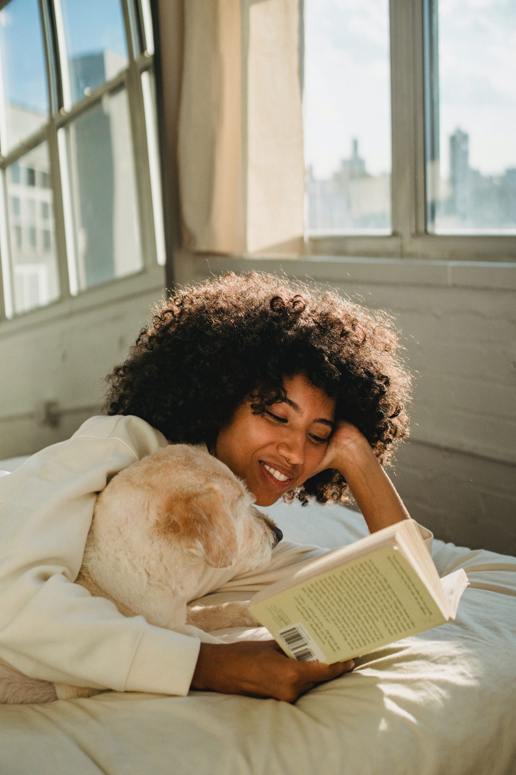 Photo by Samson Katt: https://www.pexels.com/photo/a-woman-reading-a-book-with-her-dog-5255154/