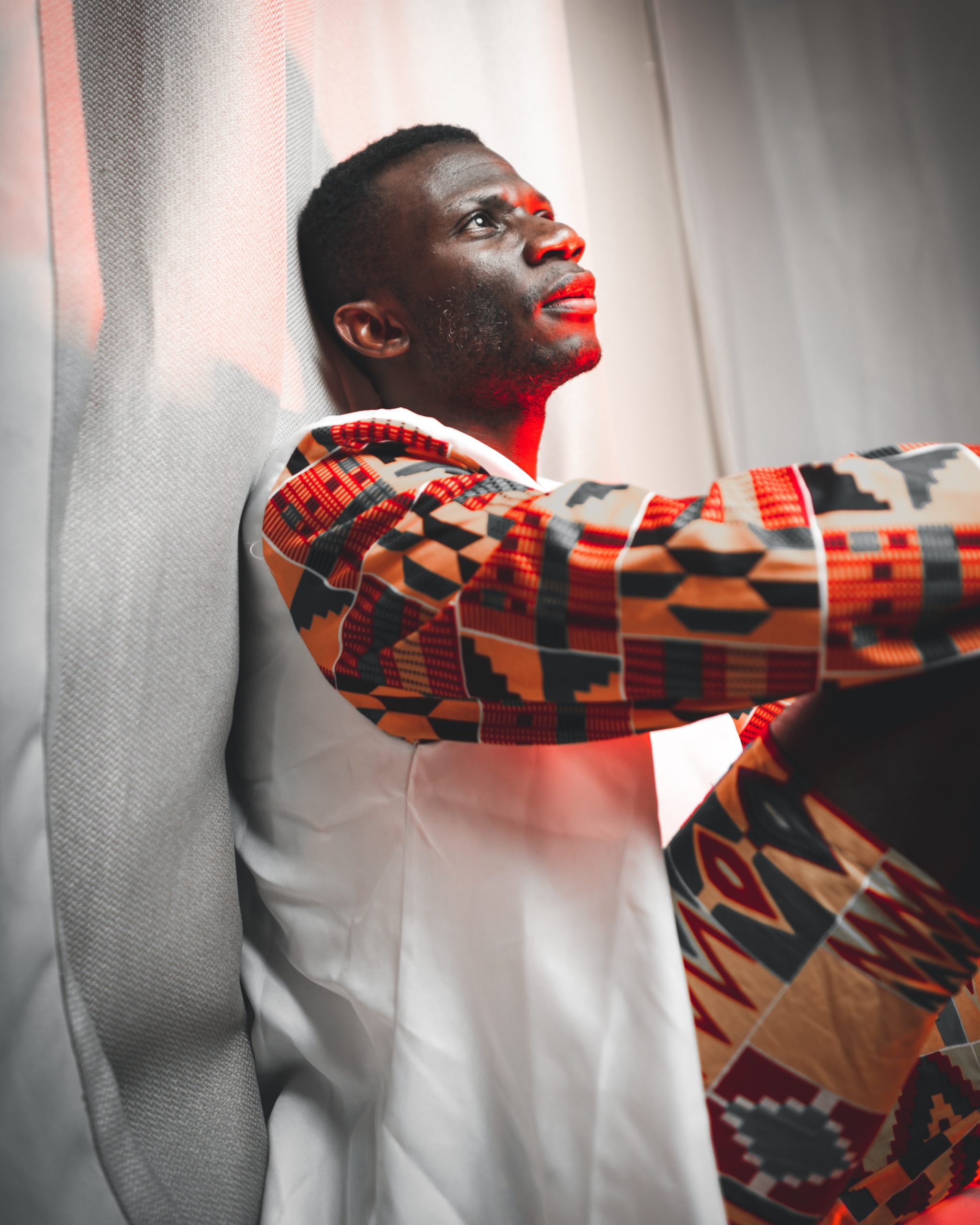 Photo by Team Maestroo: https://www.pexels.com/photo/african-man-with-frown-look-sitting-under-red-light-4320389/