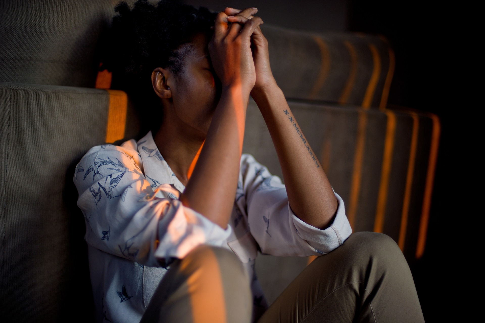 Young woman struggling with depression, debunking the mental health myth that it’s laziness